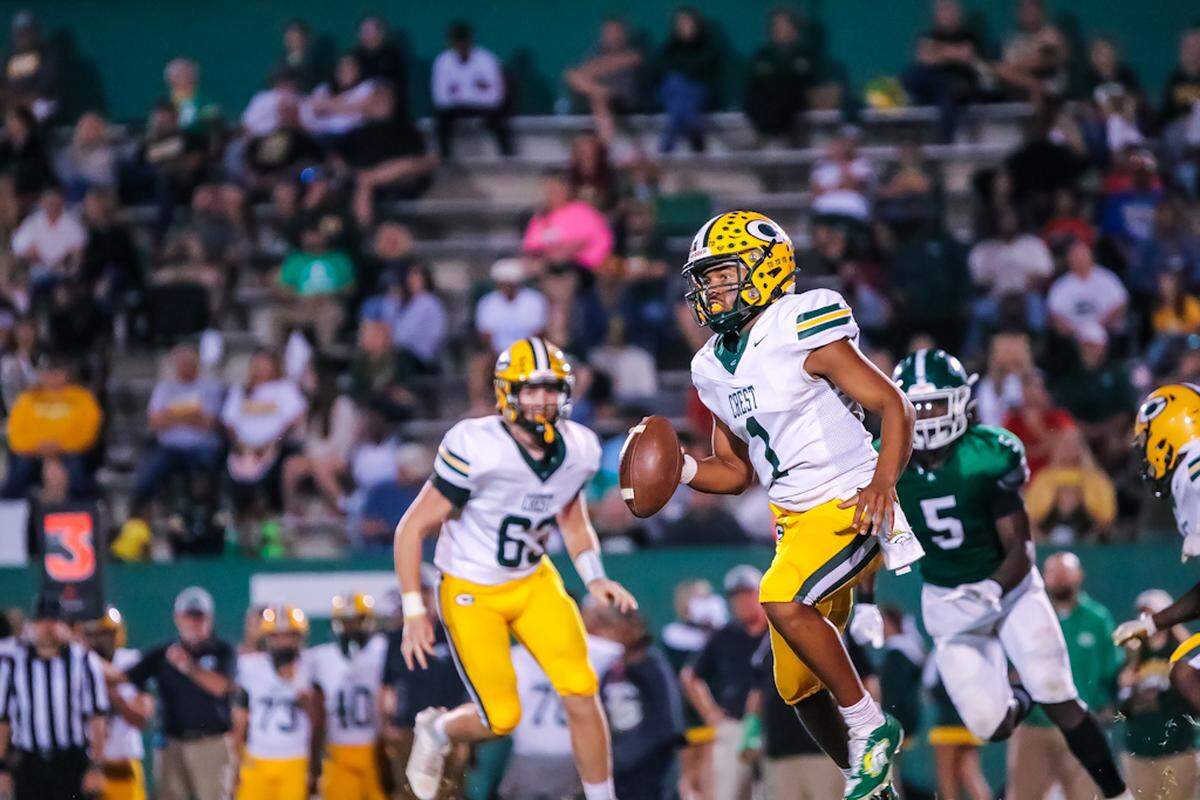 Crest Chargers quarterback Ny’tavious Husky runs the ball as he looks for an open teammate