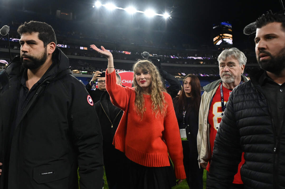 Taylor Swift (center) walks off the field after the Kansas City Chiefs won the Jan. 28, 2024 AFC Championship football game against the Baltimore Ravens at M&T Bank Stadium.