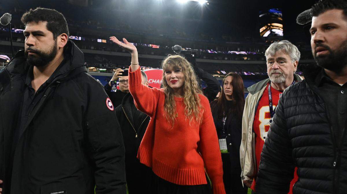 Taylor Swift (center) walks off the field after the Kansas City Chiefs won the Jan. 28, 2024 AFC Championship football game against the Baltimore Ravens at M&T Bank Stadium.