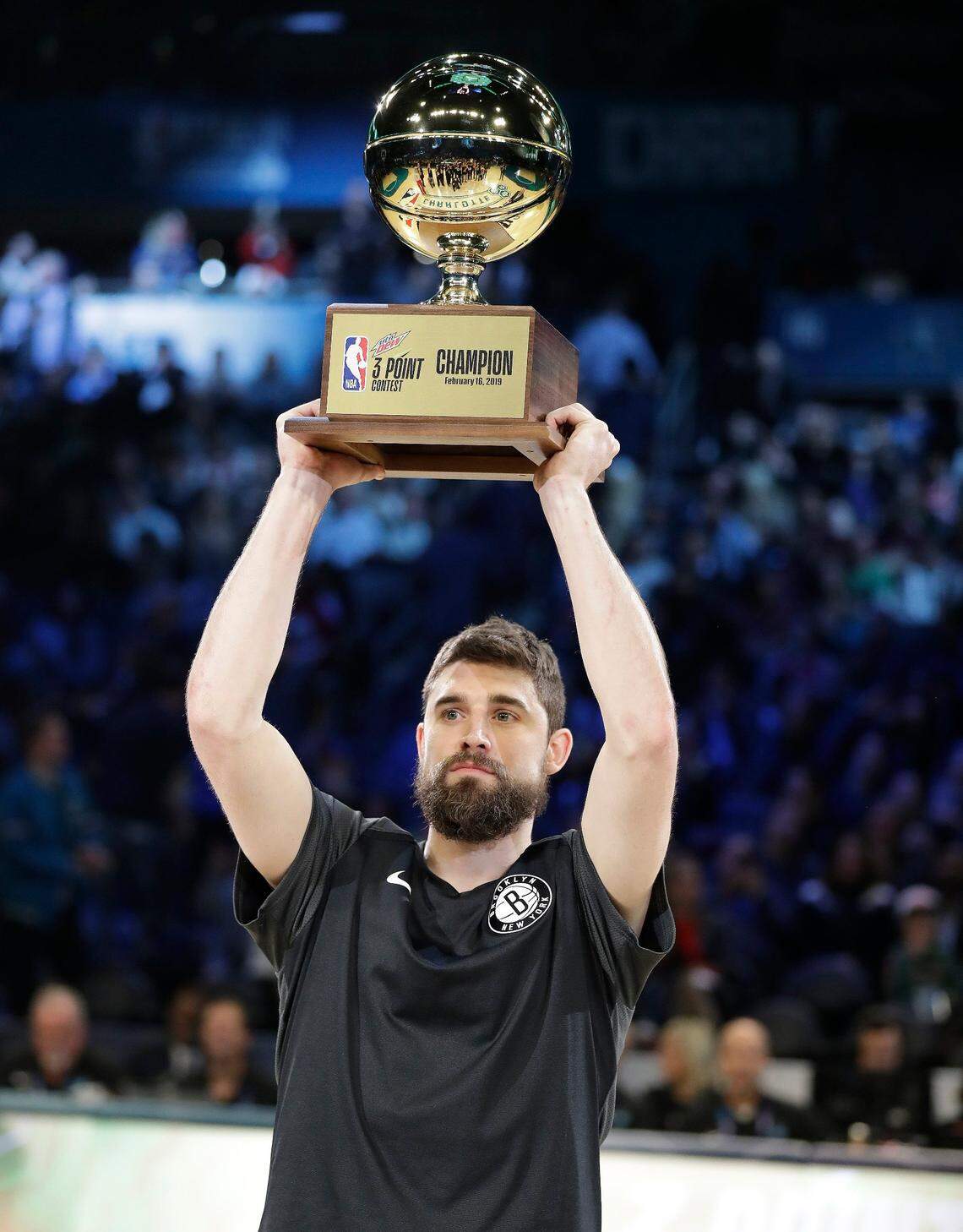 Brooklyn’s Joe Harris holds the championship trophy after winning the three-point contest during NBA All-Star Weekend Saturday night. Harris said he practiced a little at the Charlotte 49ers’ facilities due to Ron Sanchez, Charlotte’s head coach and his former assistant coach at Virginia.