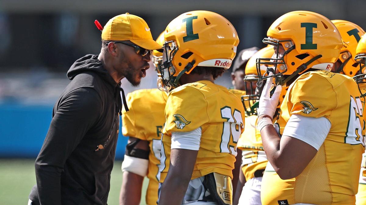 Independence Patriots head coach D.J. McFadden, left, talks with wide receiver/tight end Wisdom Whipper-Daniel, right, during action against Myers Park on Thursday, August 22, 2024 at Bank of America Stadium in Charlotte, NC. The teams are competing in the Keep Pounding High School Classic.