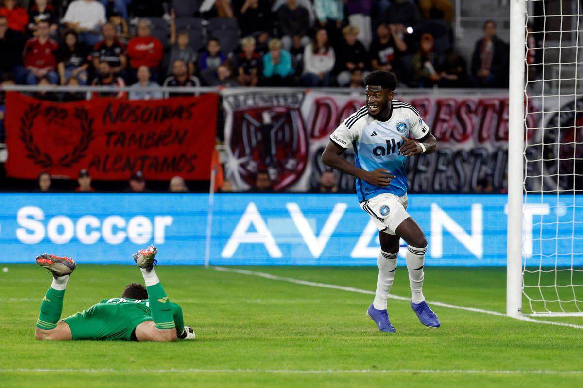 Charlotte FC forward Patrick Agyemang (33) celebrates after scoring a goal against D.C. United goalkeeper Alex Bono (24) in the second half at Audi Field.