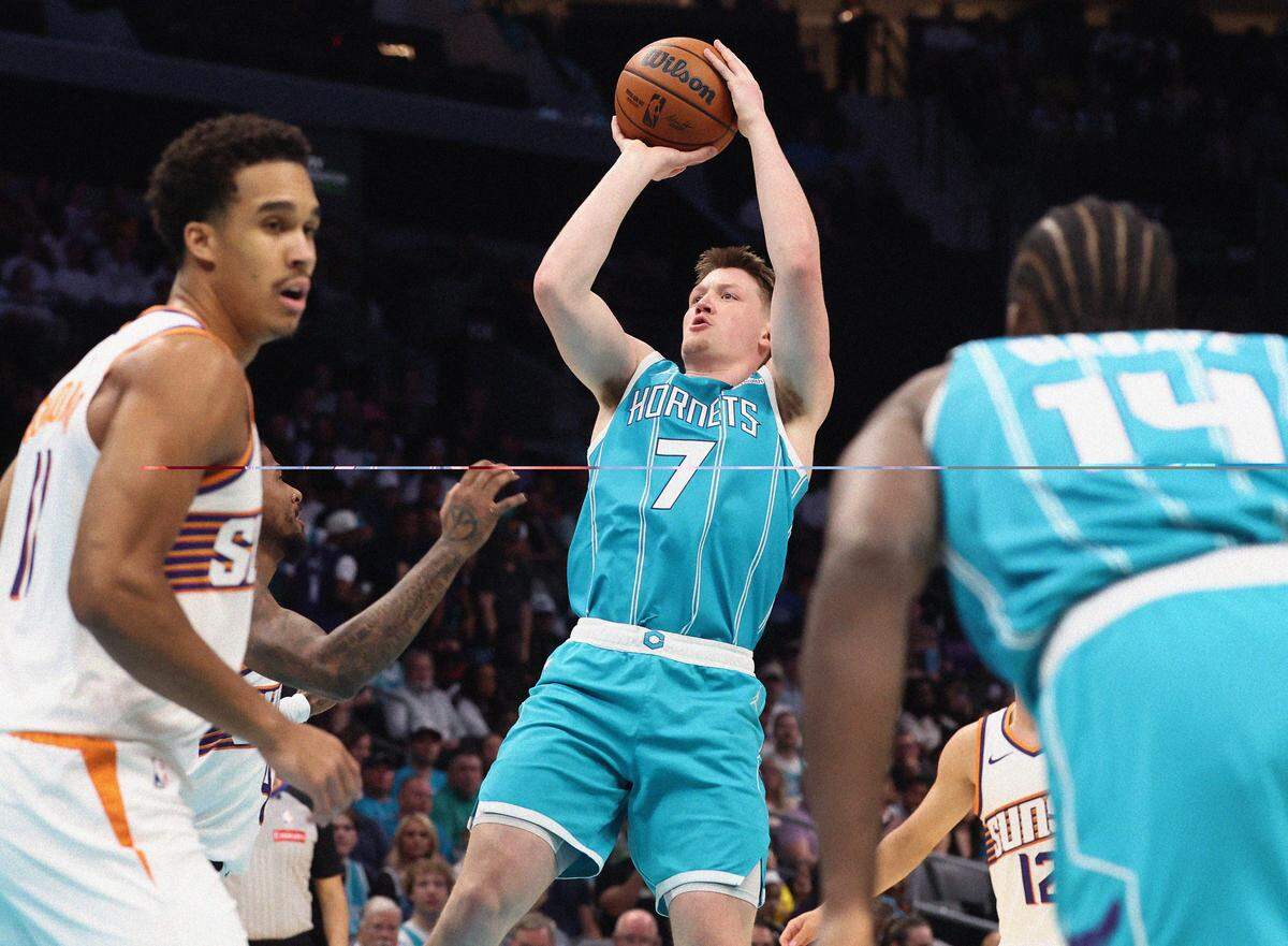 Charlotte Hornets forward Kon Knueppel, center, releases a jump shot in the lane during Thursday’s action against the Phoenix Suns at Spectrum Center. The Hornets defeated the Suns 127-107.
