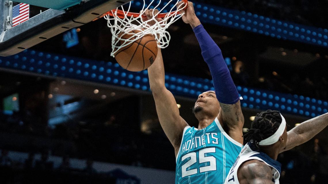 Charlotte Hornets forward P.J. Washington (25) dunks past Minnesota Timberwolves forward Jarred Vanderbilt (8) during the first half of an NBA basketball game in Charlotte, N.C., Friday, Nov. 26, 2021. (AP Photo/Jacob Kupferman)