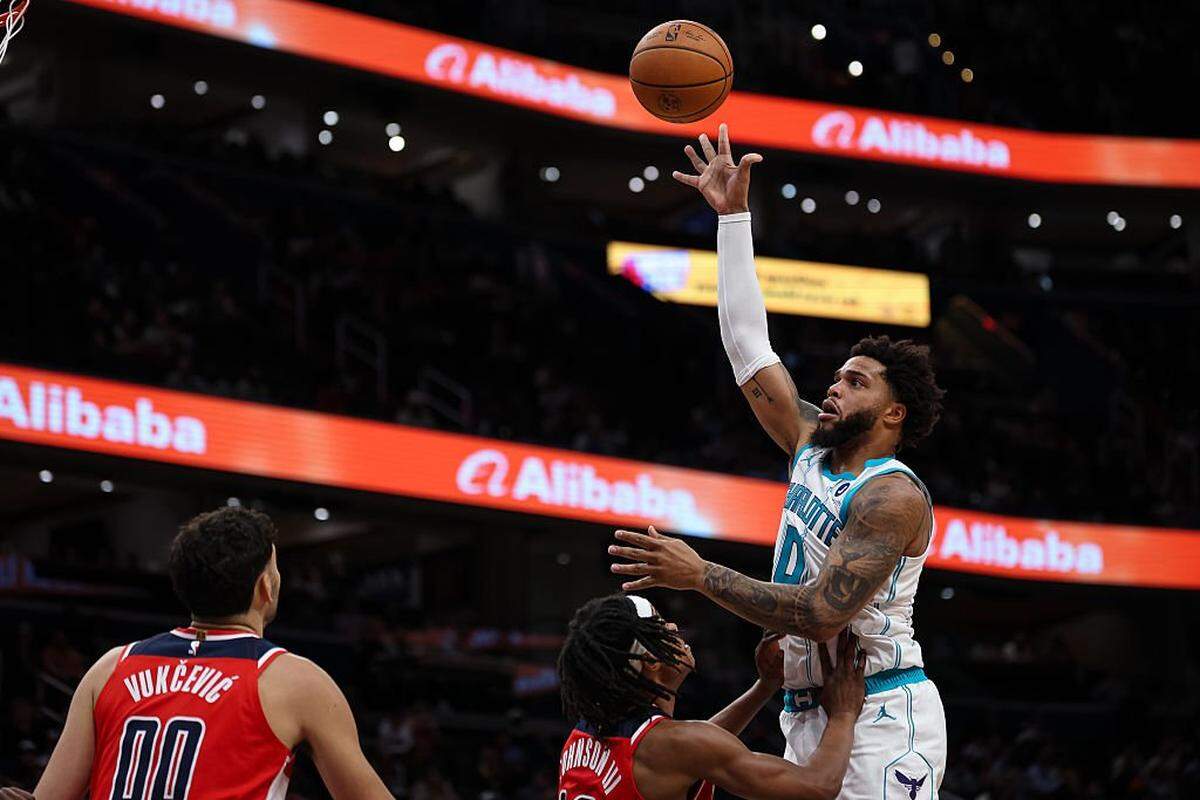 Miles Bridges (0) of the Charlotte Hornets shoots the ball against the Washington Wizards during the first half at Capital One Arena on October 26, 2025 in Washington, DC.