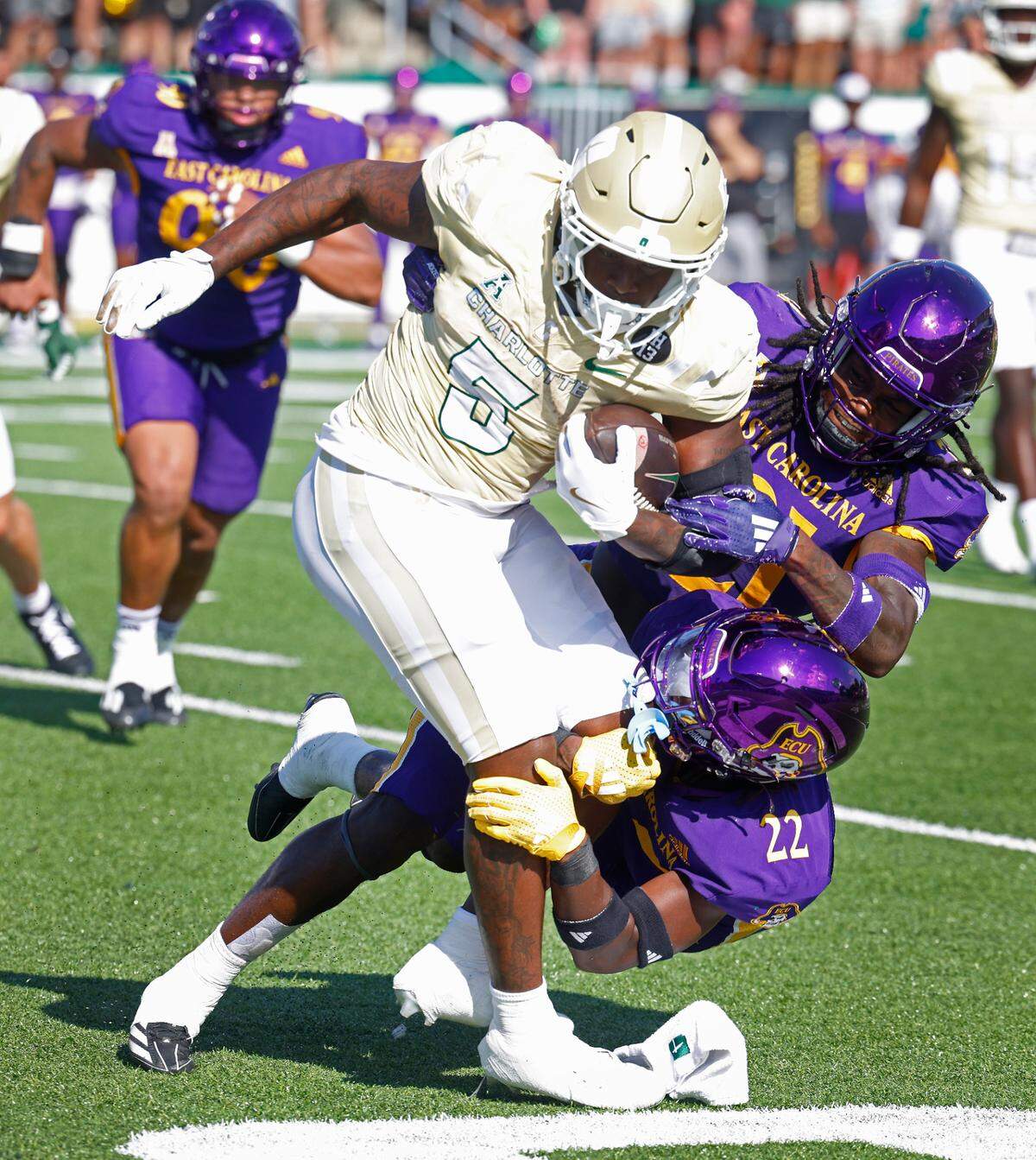 Charlotte 49er’s running back Cartevious Norton, left, fights for yardage as the East Carolina defense works to make the tackle on Saturday, October 5, 2024 at Jerry Richardson Stadium in Charlotte, NC.