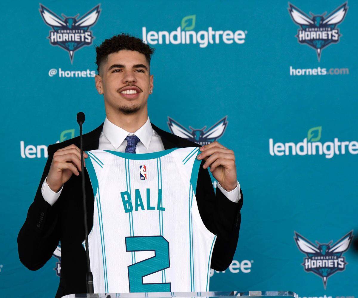 Charlotte Hornets 2020 first round draft pick LaMelo Ball holds up his jersey during a press conference outside the Spectrum Center on Friday, November 20, 2020.