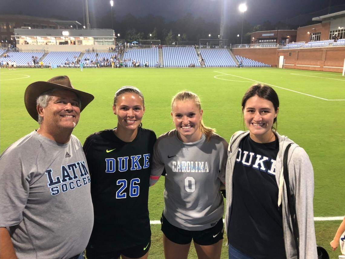 Former Charlotte Latin coach Lee Horton, left, poses for a photo with Ruthie Jones (26) and Claudia (0) at a UNC-Duke soccer match, along with Jones’ older sister, Becca, who played field hockey at Davidson.