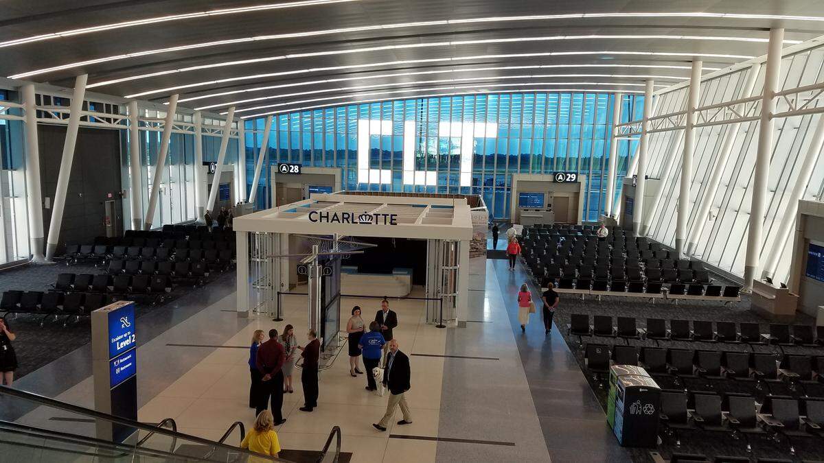The new Concourse A North, with nine gates, opened in July at Charlotte Douglas International Airport. The new gates offer more amenities, such as outlets in every seat and more space for passengers, as Charlotte balances its low-cost, no-frills past with a flashier future.