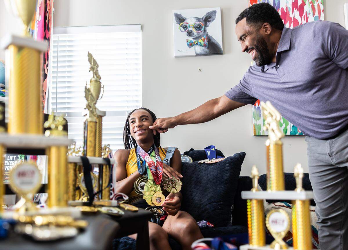 Mylan Clay, photographed with her dad Mike in their Harrisburg home, says her relationship with the other girls has definitely benefited them all as competitors. “It’s like iron sharpens iron. We just push each other to be better.”