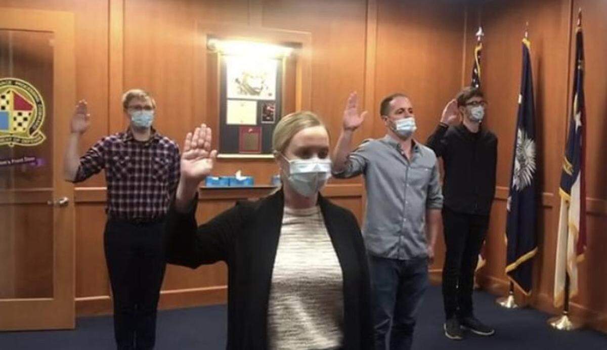 A screenshot from a Facebook Live of Sarah Blake Morgan being sworn in at her enlistment ceremony at the Charlotte Military Entrance Processing Station in October.