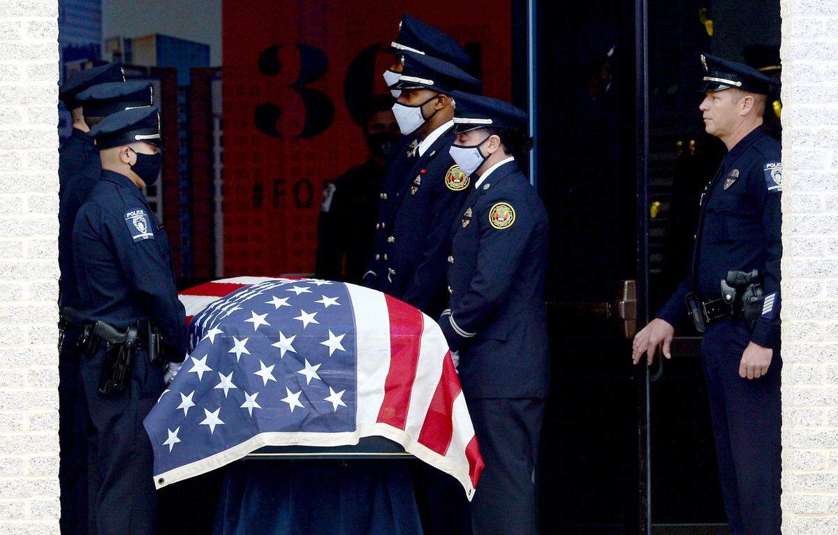 An honor guard of Charlotte-Mecklenburg Police officers and Charlotte Fire move the casket of CMPD Officer Mia Goodwin into First Baptist Church on Wednesday, December 29, 2021. Officer Goodwin was killed while responding to a crash on Interstate 85 on December 22, 2021.