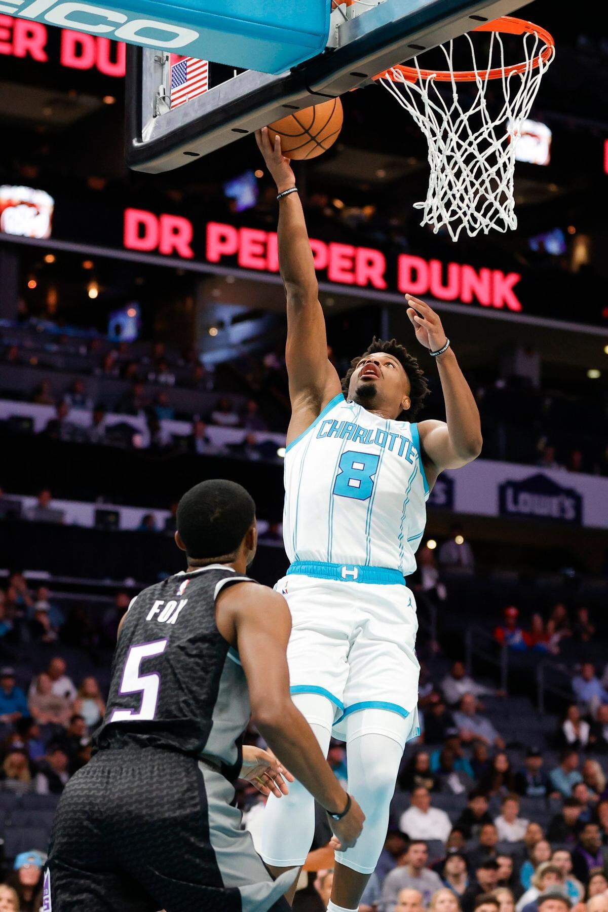 Charlotte Hornets guard Dennis Smith Jr. (8) shoots over Sacramento Kings guard De’Aaron Fox (5) during a game at Spectrum Center in Charlotte, N.C., Monday, Oct. 31, 2022.