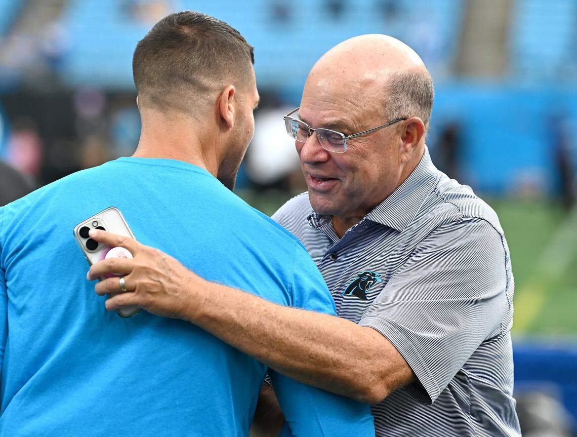 Carolina Panthers head coach Dave Canales, left, speaks with team owner David Tepper prior to the team’s 2024 game against the Los Angeles Chargers.