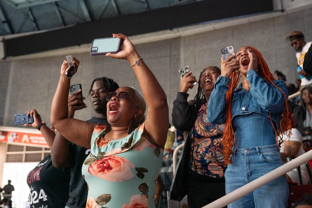 Stephanie Gray, the great aunt of West Charlotte High School graduate J’Sean Wilson, records a video of him receiving his diploma at the Bojangles Coliseum in Charlotte on Monday, June, 10, 2024.