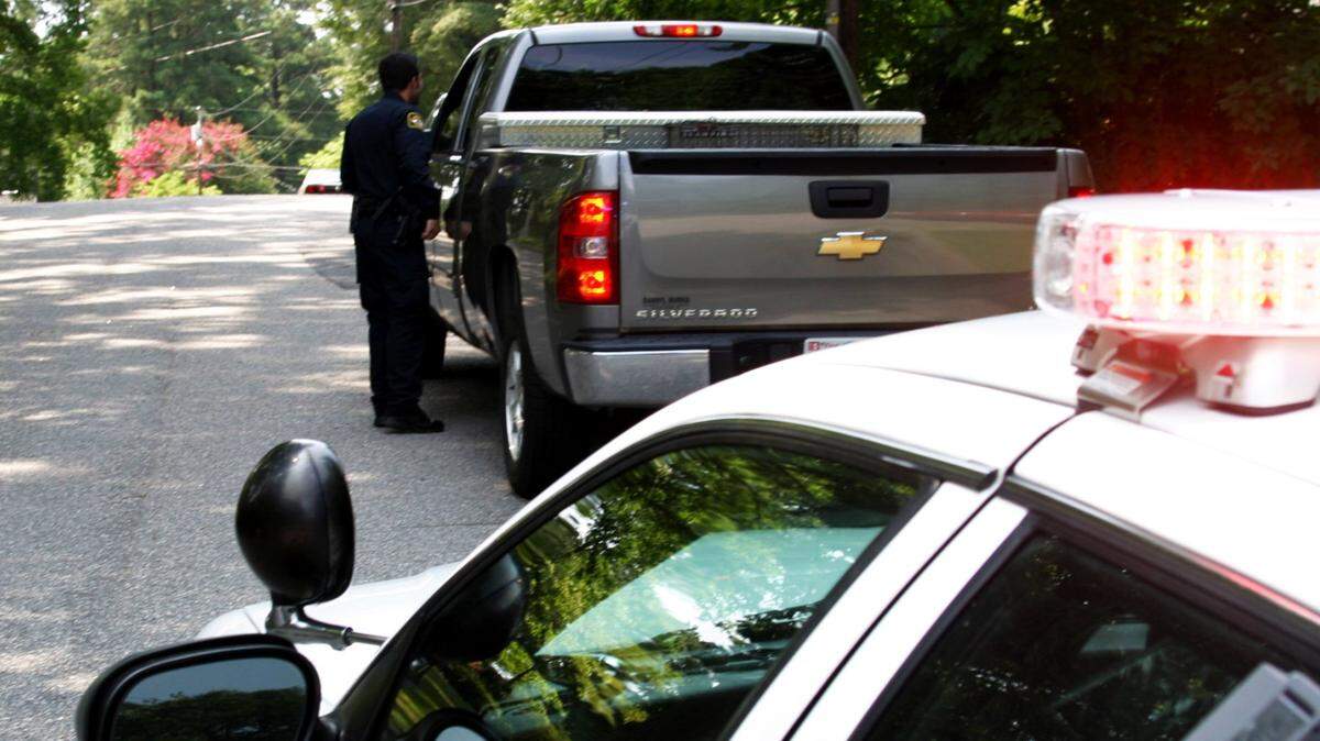 Garner police officer Frank Hughes talks to a driver during a staged traffic stop.