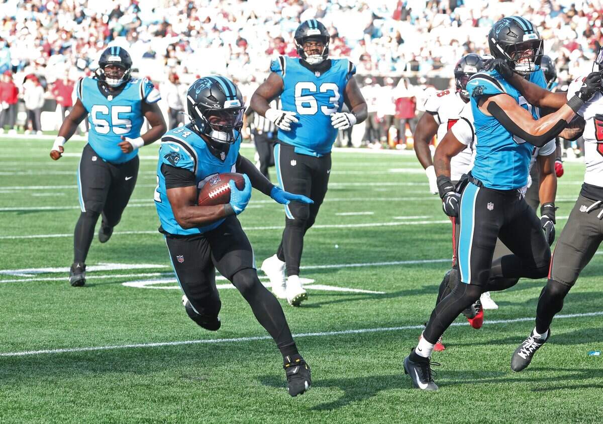 Carolina Panthers running back Anthony Tyus III, left, rushes for a touchdown against the Tampa Bay Buccaneers at Bank of America Stadium in Charlotte, NC on Sunday, October 25, 2026.