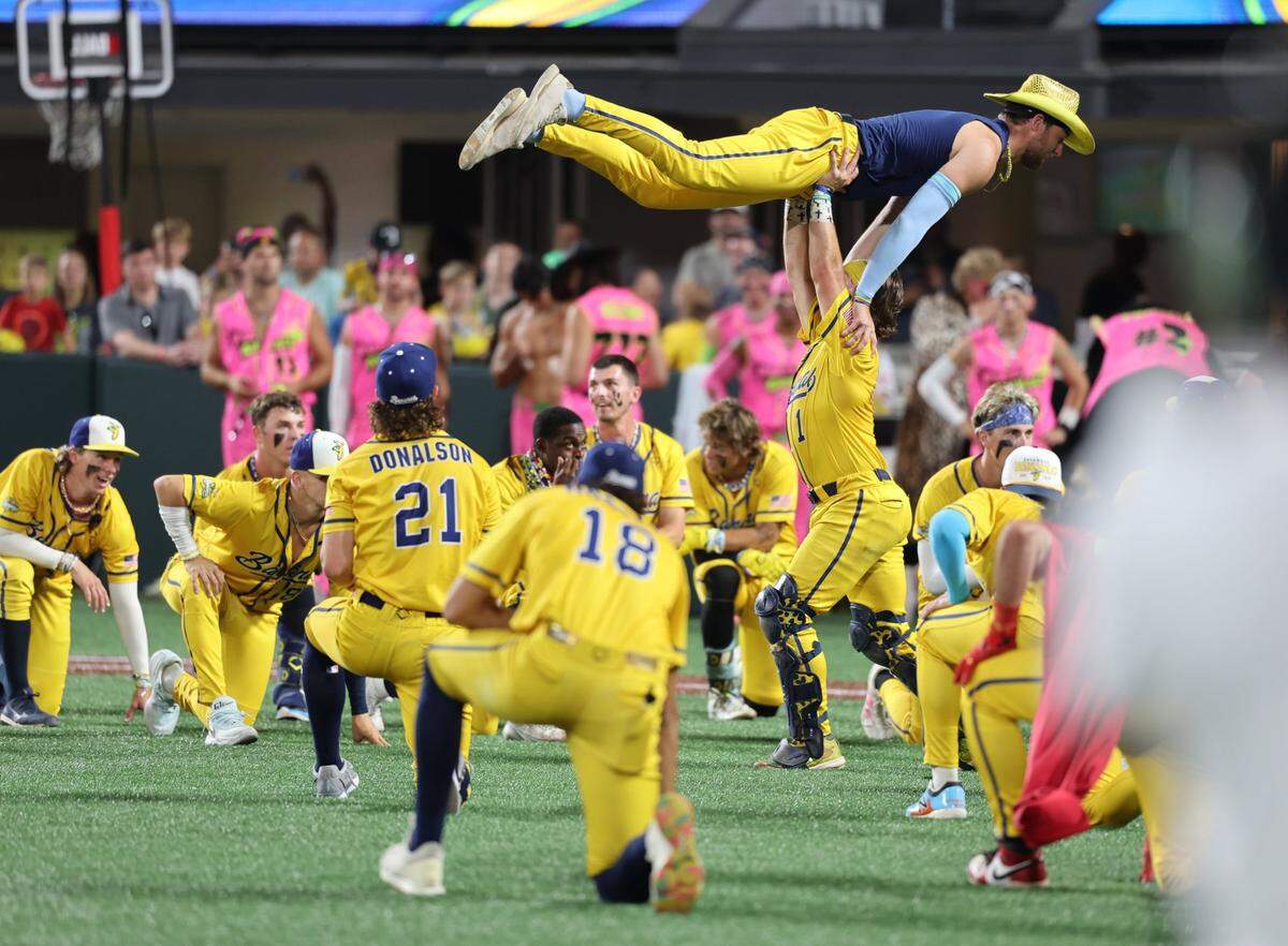 The Savannah Bananas celebrate their victory over the Party Animals at Bank of America Stadium in Charlotte on Friday, June 6, 2025.