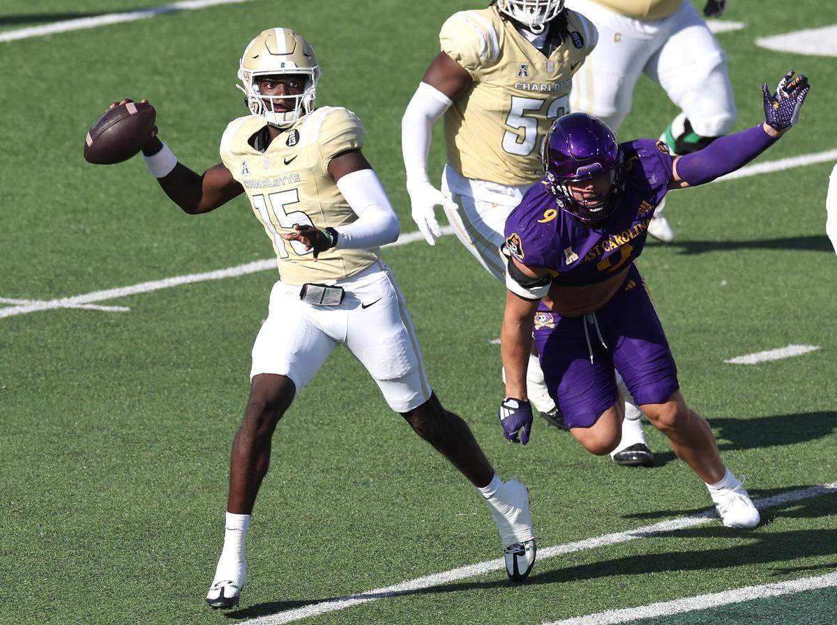 Charlotte 49er’s quarterback Deshawn Purdie, left, scrambles out of the pocket to pass to a receiver during action against East Carolina on Saturday, October 5, 2024 at Jerry Richardson Stadium in Charlotte, NC.