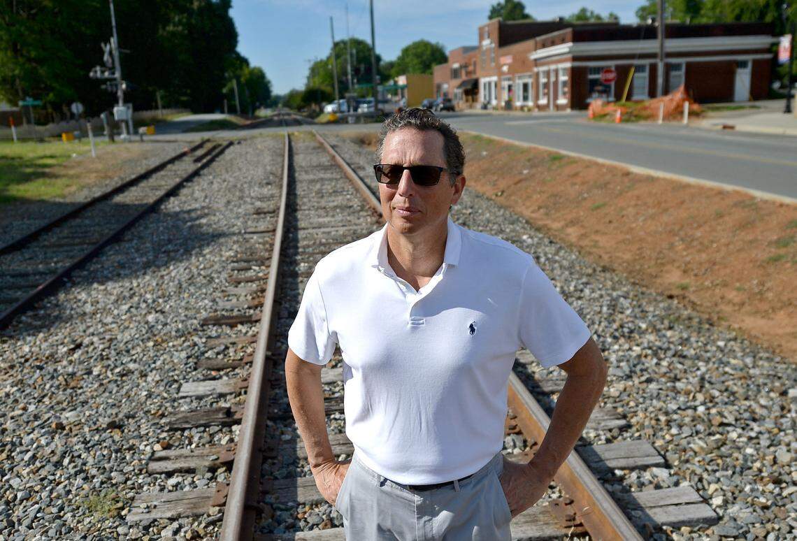 Huntersville Mayor John Aneralla stands on the railroad tracks that Charlotte leaders want to use for the proposed LYNX Red Line commuter train. The track is owned by Norfolk Southern Corp., which for years has refused to share its “O Line” with CATS and the city.