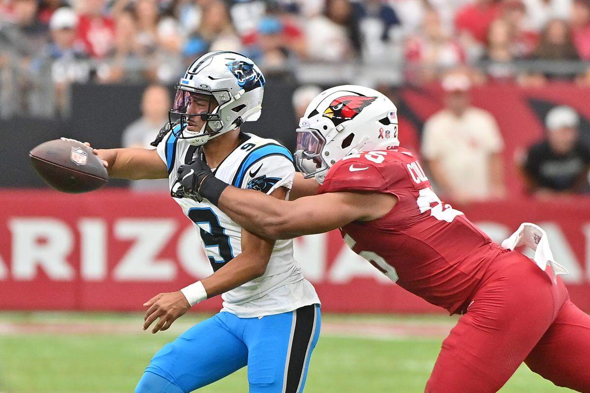 Arizona Cardinals linebacker Baron Browning (5) reaches for Carolina Panthers quarterback Bryce Young (9) during Sunday’s first quarter at State Farm Stadium. 