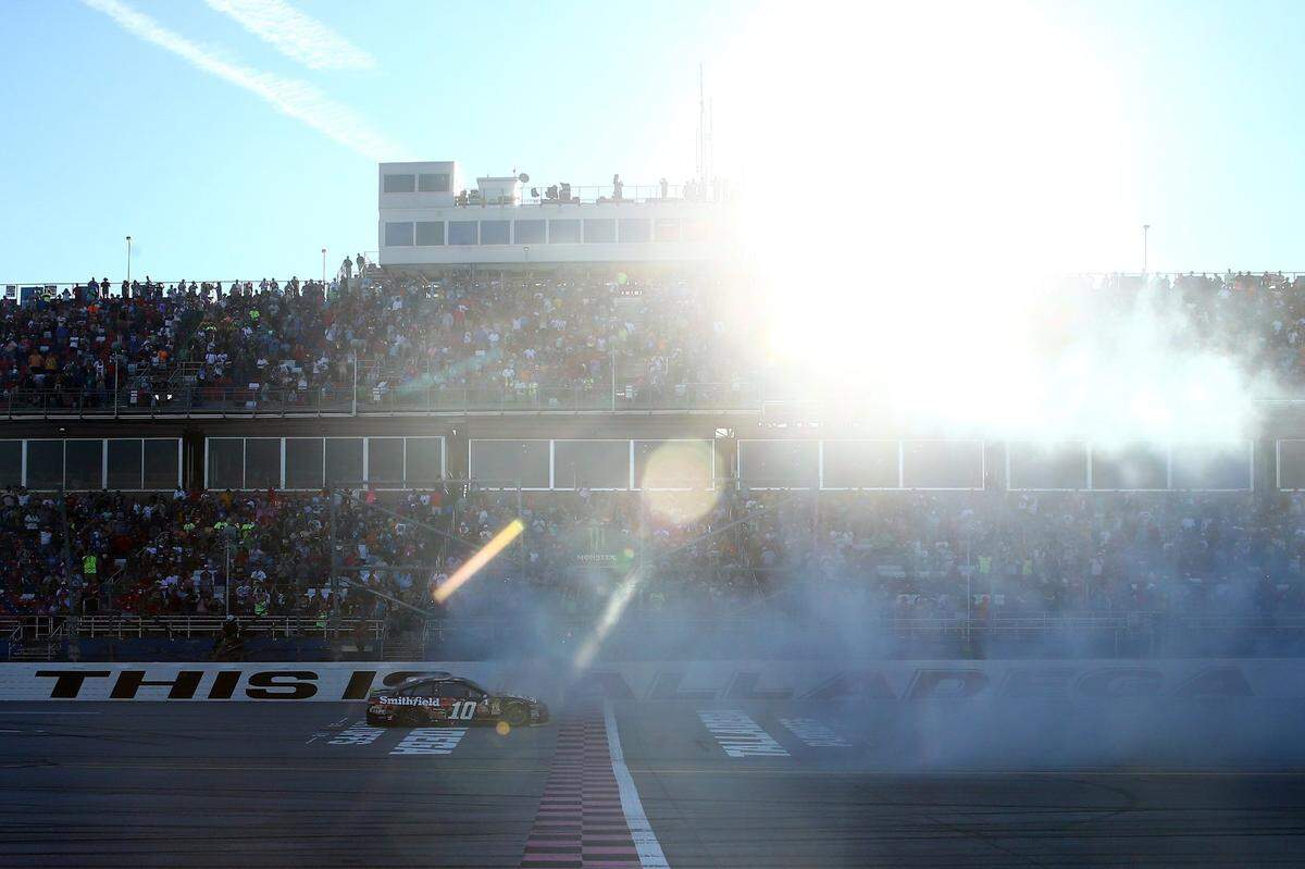 TALLADEGA, AL - OCTOBER 14: Aric Almirola, driver of the #10 Smithfield Bacon for Life Ford, celebrates with a burnout after winning the Monster Energy NASCAR Cup Series 1000Bulbs.com 500 at Talladega Superspeedway on October 14, 2018 in Talladega, Alabama. (Photo by Chris Graythen/Getty Images)
