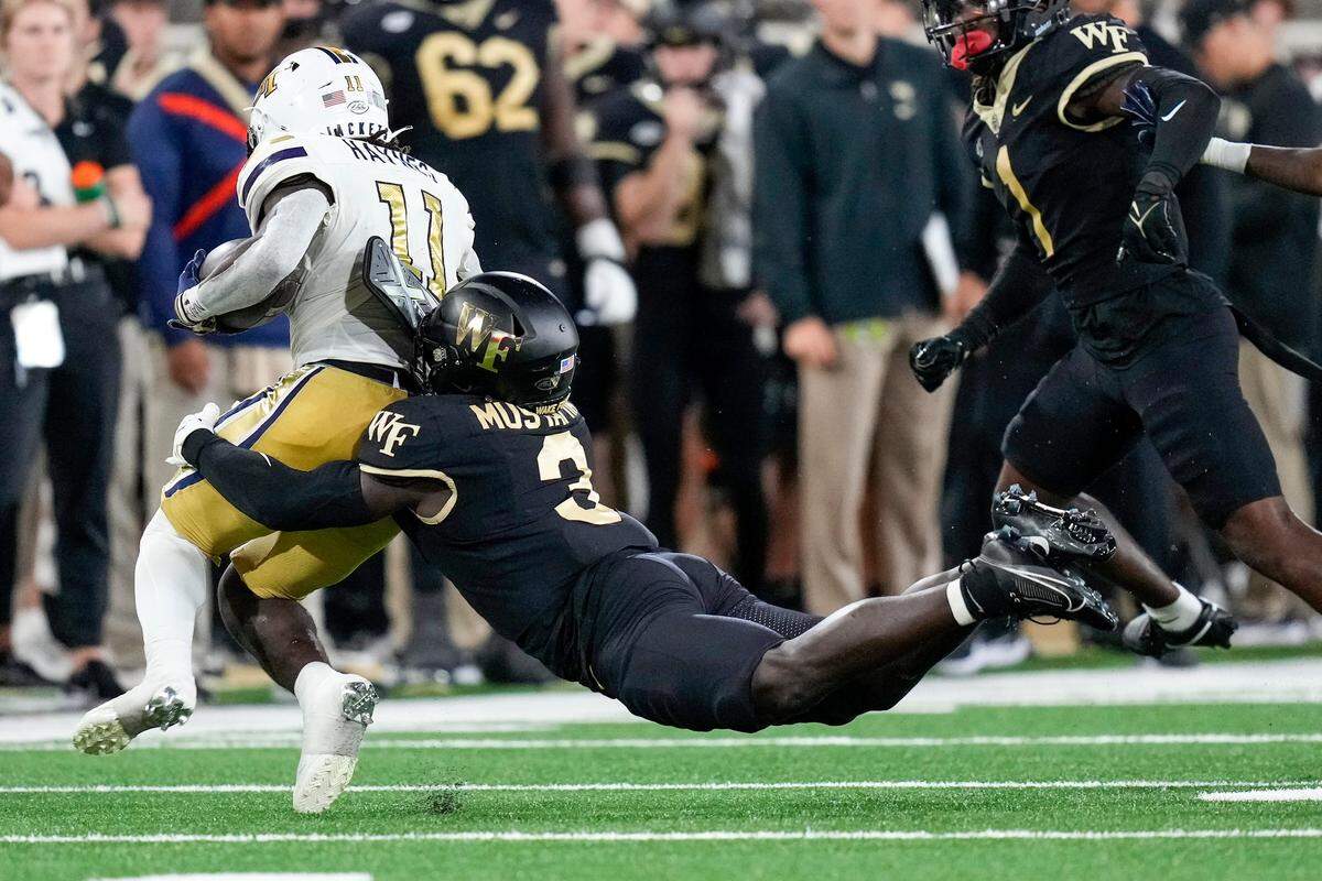 Wake Forest Demon Deacons defensive back Malik Mustapha (3) dives to tackle Georgia Tech Yellow Jackets running back Jamal Haynes (11) during the second half of their 2023 game. Jim Dedmon-USA TODAY Sports