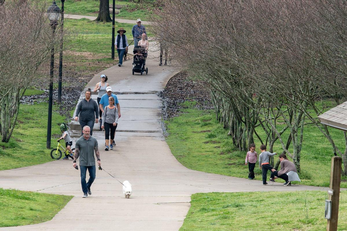 People walk, jog and ride bicycles at Freedom Park in Charlotte on Thursday, March 19, 2020.