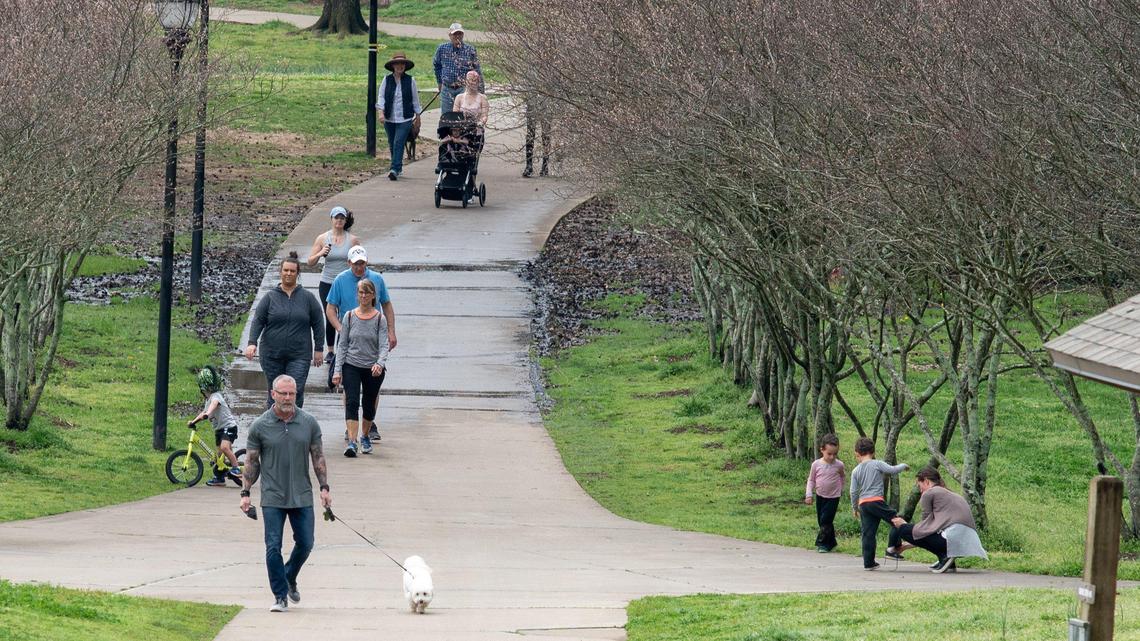 People walk, jog and ride bicycles at Freedom Park in Charlotte on Thursday, March 19, 2020.