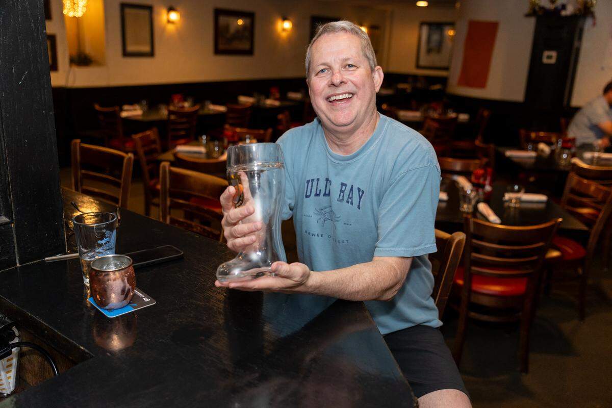 Longtime Sir Ed’s patron Gary Webb holds a classic beer boot, similar to the ones he regularly drank out of at the Bavarian House, the restaurant that preceded Sir Edmond Halley’s at the same location in the ’80s and early ’90s.
