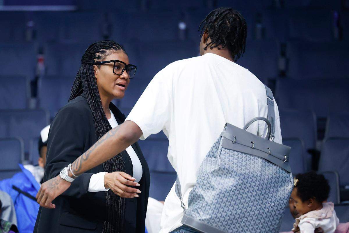 Angela Washington, mother of both Minnesota Timberwolves forward Jaden McDaniels (3) and Charlotte Hornets forward Jalen McDaniels (6) speaks with Jaden after a game at Spectrum Center in Charlotte, N.C., Friday, Nov. 25, 2022.