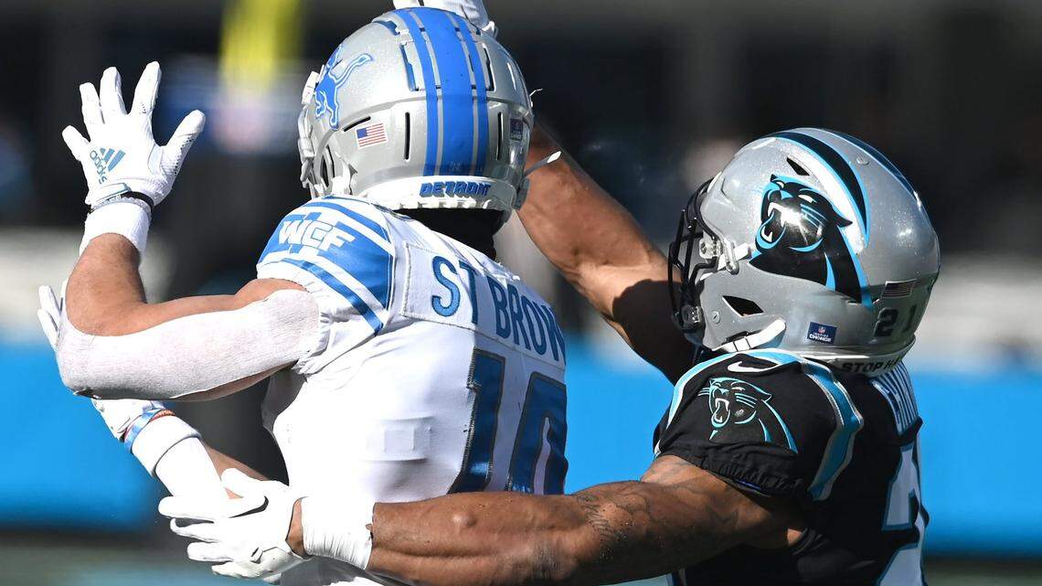 Carolina Panthers safety Jeremy Chinn, right, breaks up a pass meant for Detroit Lions wide receiver Amon-Ra St. Brown, left, during first quarter action at Bank of America Stadium on Saturday, December 24, 2022 in Charlotte, NC.