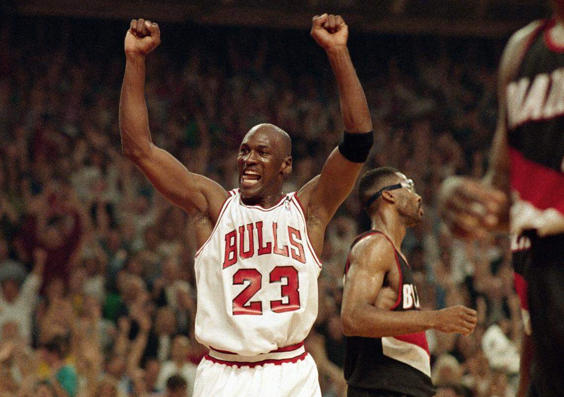 FILE - In this June 14, 1992, file photo, Michael Jordan celebrates the Bulls win over the Portland Trail Blazers in the NBA Finals in Chicago. Decades after Jordan’s groundbreaking departure from college, March Madness and the NBA’s mega-millions have taken all the novelty out of leaving early for the pros. (AP Photo/John Swart, File)