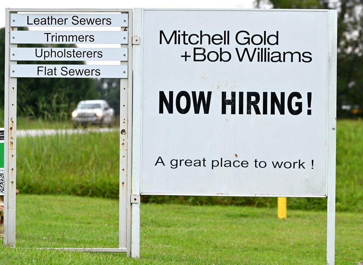 The Mitchell Gold + Bob Williams furniture company based in Taylorsville, N.C., closed abruptly in August with over 530 job cuts. Along with signs from other companies hiring, Mitchell Gold’s still has a sign at the Taylorsville facility that says “Now Hiring!”