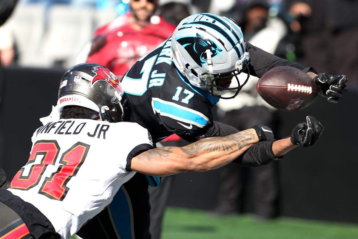 Carolina Panthers wide receiver DJ Chark, right, fumbles the football at the goal line as he is hit by Tampa Bay Buccaneers safety Antoine Winfield Jr., left, during second-quarter action at Bank of America Stadium in Charlotte, NC on Sunday, January 7, 2024.