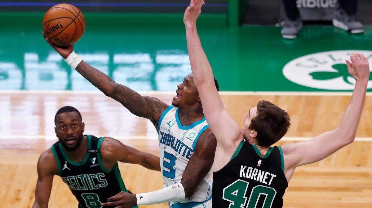 Charlotte Hornets’ Terry Rozier (3) shoots between Boston Celtics’ Kemba Walker (8) and Luke Kornet (40) during the second half of an NBA basketball game Sunday, April 4, 2021, in Boston. (AP Photo/Michael Dwyer)