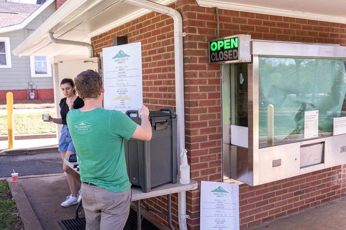Summit Coffee employees offer street service coffee sales to cars that drive up to order in Davidson, NC.