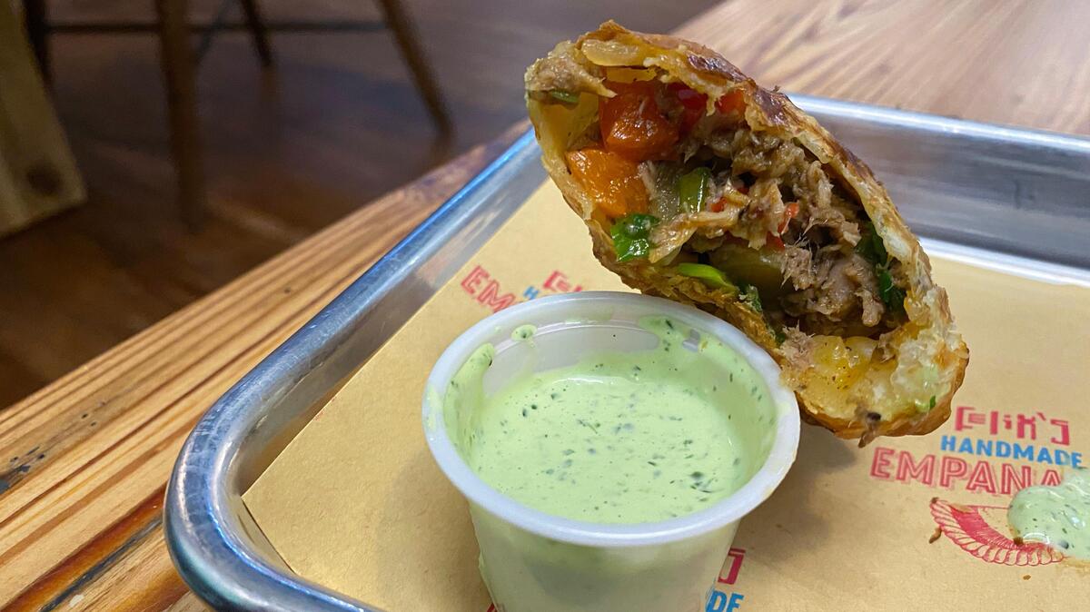 The pulled chorizo empanada at Felix Empanadas comes with a cilantro dipping sauce.