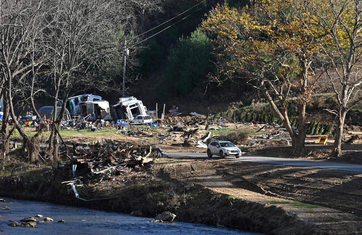 A motorist passes by the destruction left by Hurricane Helene in Burnsville on Monday, Nov. 25, 2024.