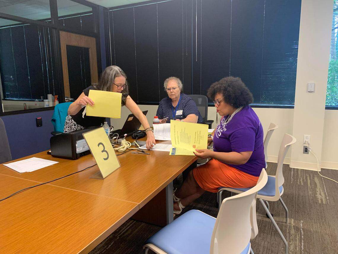 Shamaiye Haynes (right), a first-time candidate for an at-large seat on the Charlotte-Mecklenburg school board, fills out paperwork to get on the ballot Friday at the Mecklenburg County Board of Elections.