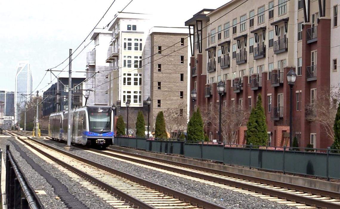 A light rail train passes through New Bern Street at Rail Crossing Lane station heading to uptown Charlotte.