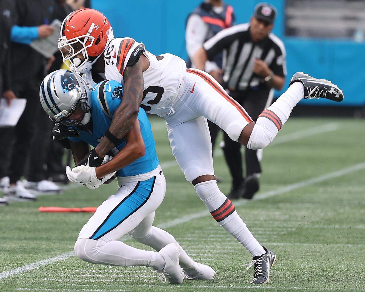 Carolina Panthers wide receiver Tetairoa McMillan, left, catches a deep pass from quarterback Bryce Young as Cleveland Browns cornerback Chigozie Anusiem, right, attempts to make the stop during action on Aug. 8, 2025, at Bank of America Stadium.