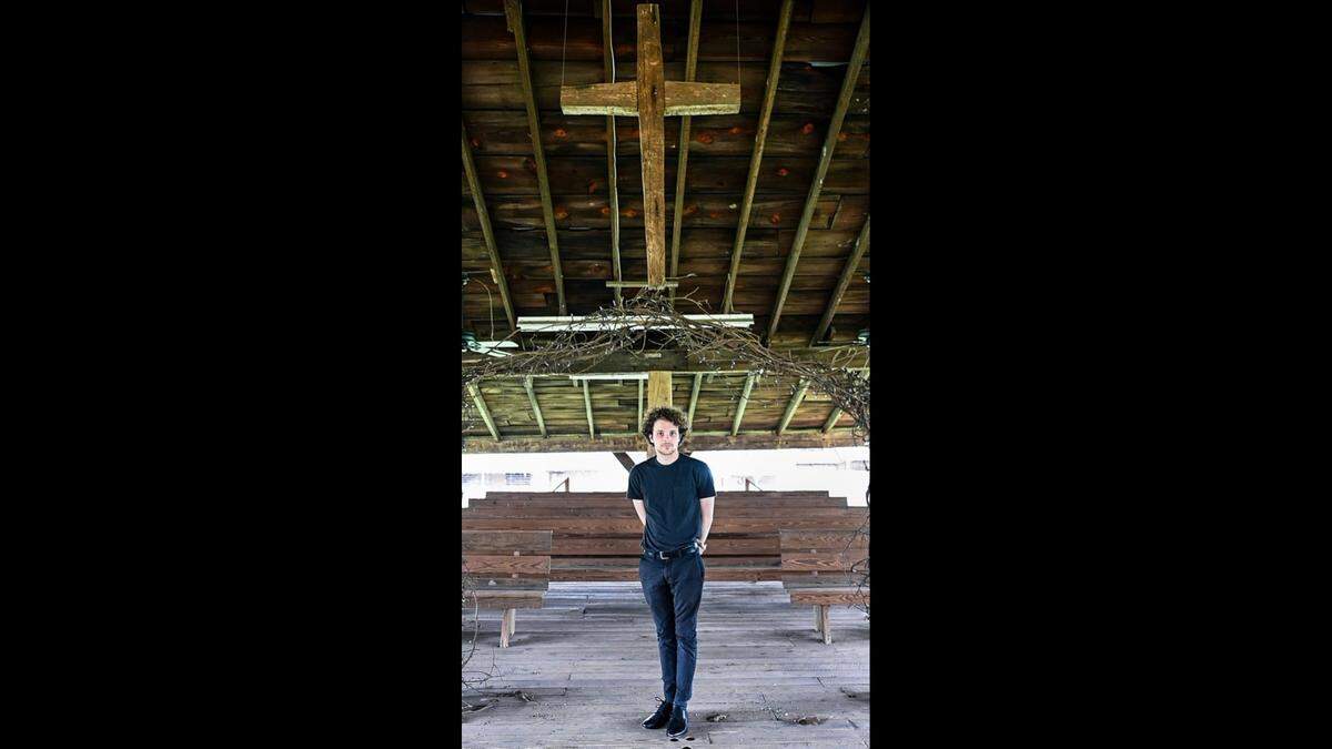 Wyatt Manlove, 25, stands at the worship space at Rock Springs Campground in Denver, North Carolina. “I felt my spiritual journey was better off in my own hands than in the hands of an institution,” says Manlove about why he does not attend church. Manlove is a graduate student in the Religious Studies Department at UNC Charlotte.
