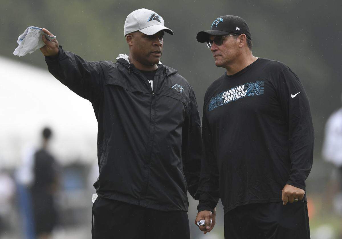 Carolina Panthers defensive coordinator Eric Washington, left, and head coach Ron Rivera, right, talk strategy last season.