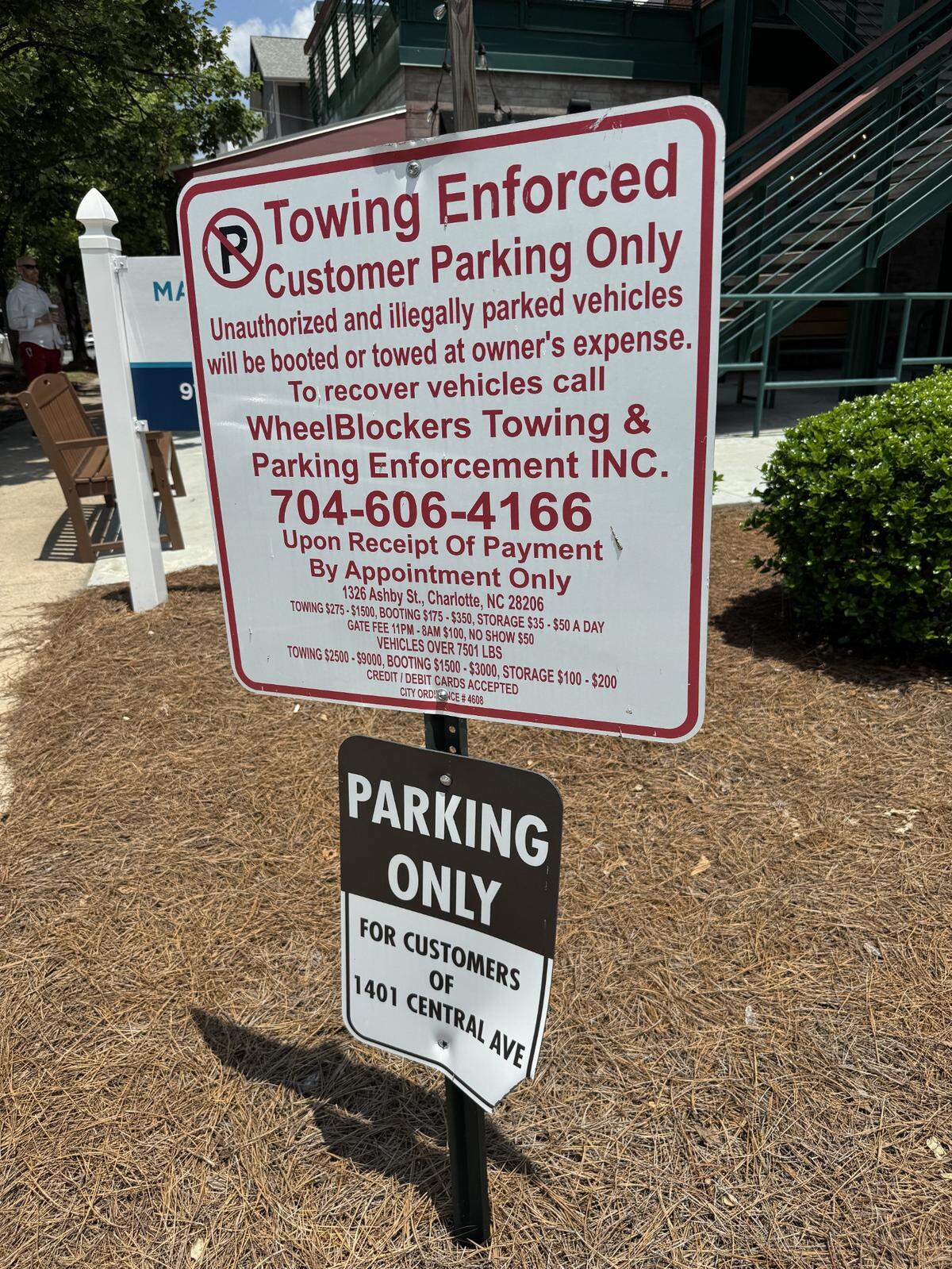 The signs posted at the entrance of the parking lot for 1401 Central Ave.
