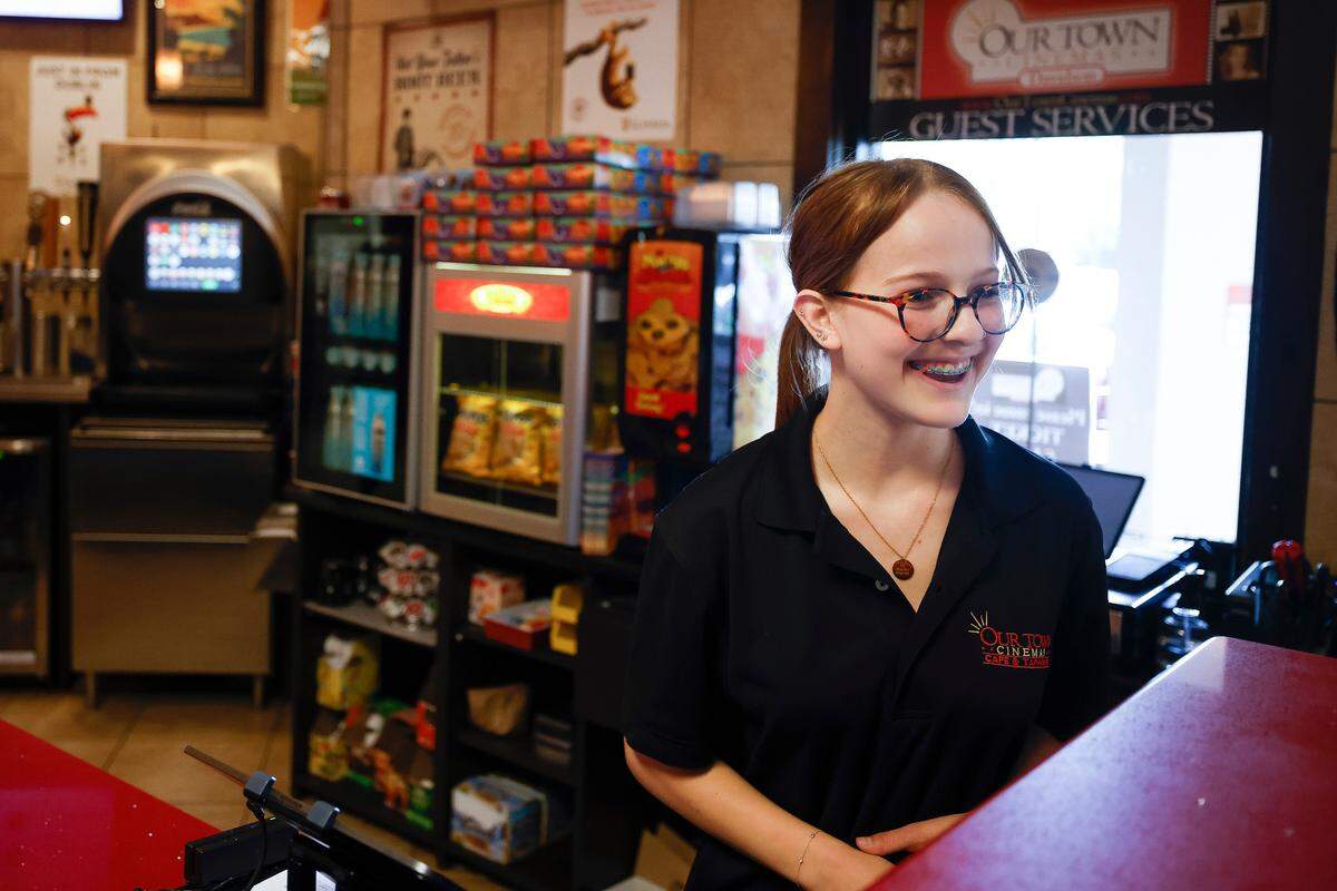 Lilly Randall, spoke with a customer after checking a ticket at Our Town Cinemas in Davidson in this 2022 file photo.
