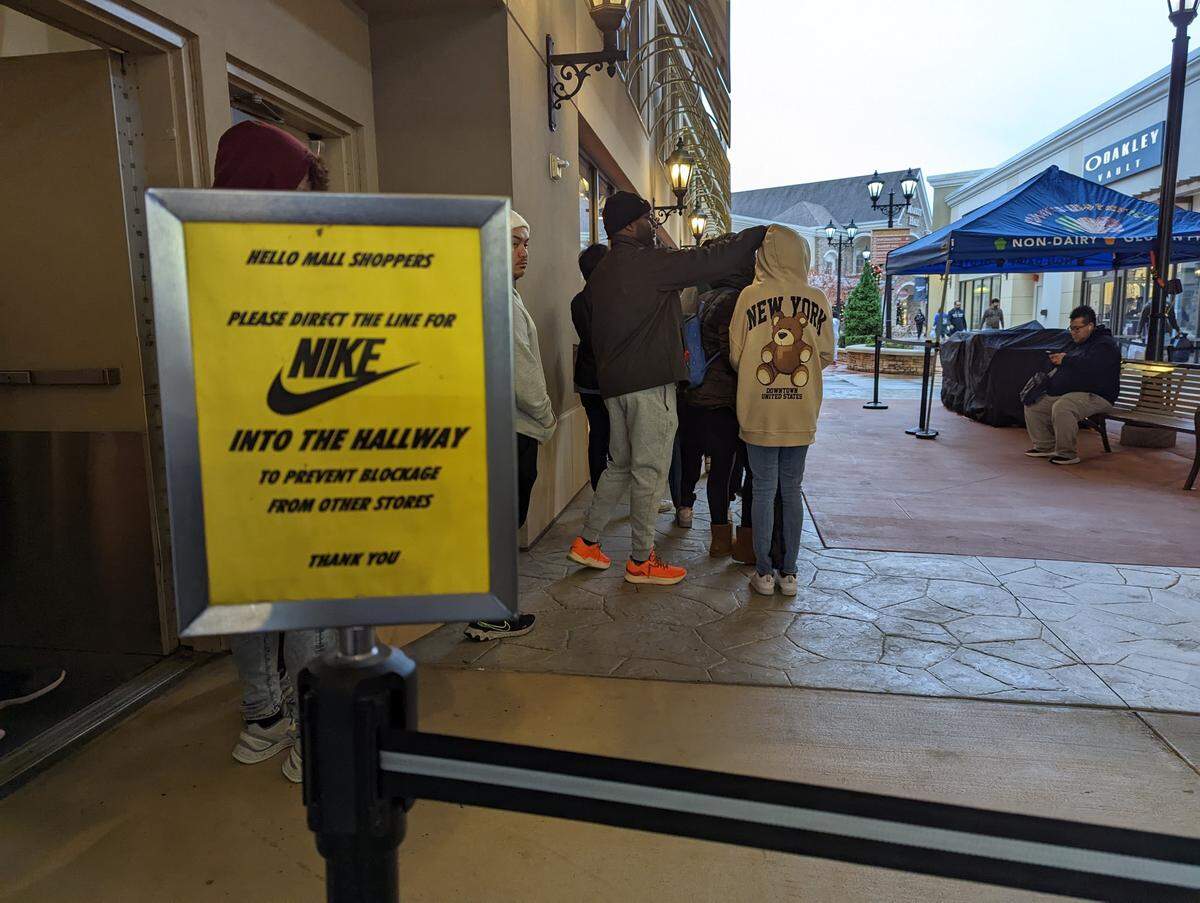 One of the longest lines at Charlotte Premium Outlet stores early on Black Friday morning was a Nike, which included a sign directing people to a nearby hallway to wait.
