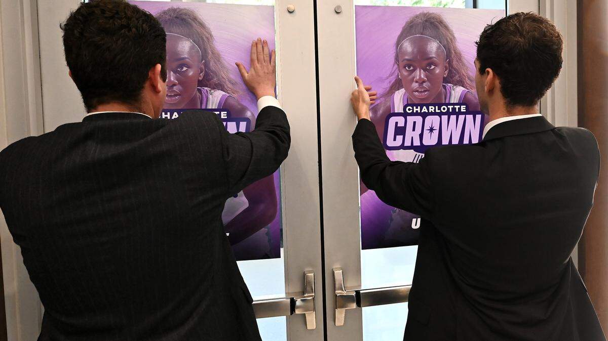 Personnel hang posters for the new Charlotte Upshot League women's team the Charlotte Crown during a press conference on Thursday, October 9, 2025 in Charlotte, NC.