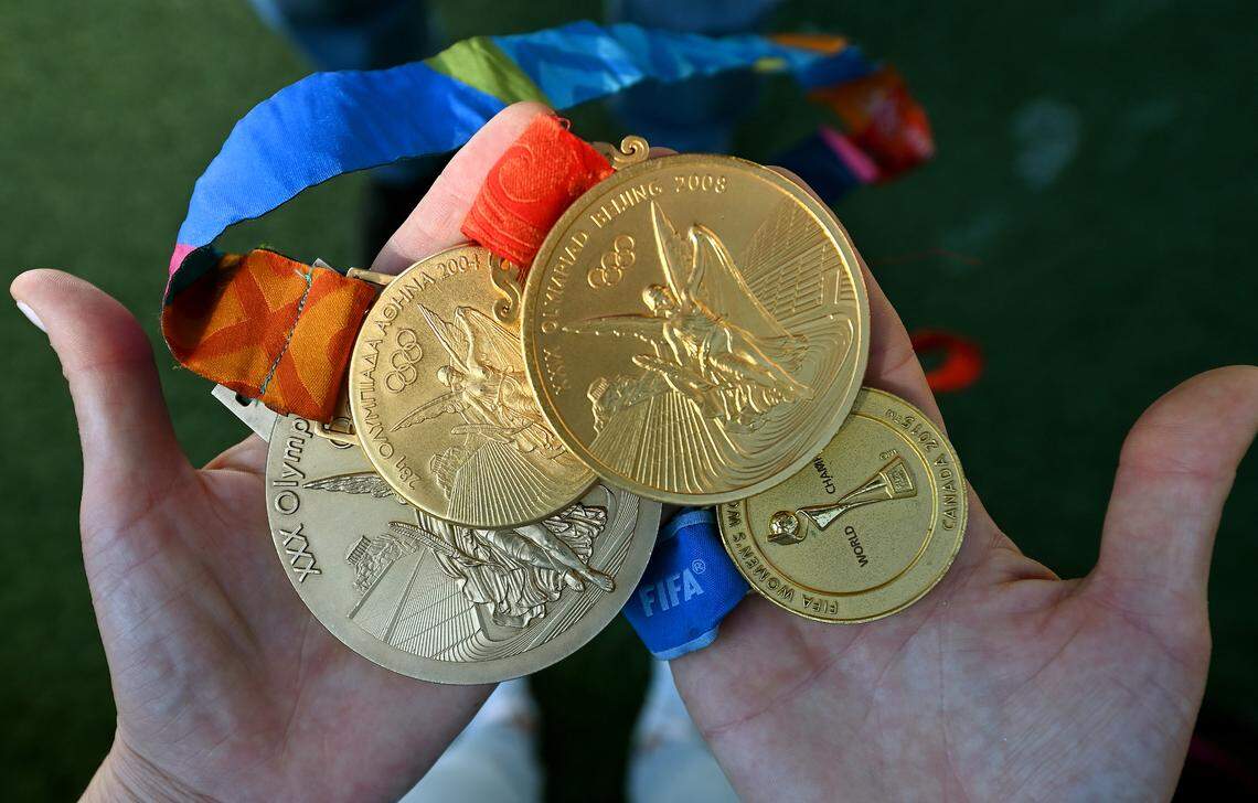Heather O’Reilly holds some of the medals from her women’s soccer career. O’Reilly won three Olympic gold medals in 2004, 2008 and 2012 and a FIFA Women’s World Cup gold medal in 2015. She played collegiately at the University of North Carolina, winning two NCAA titles.