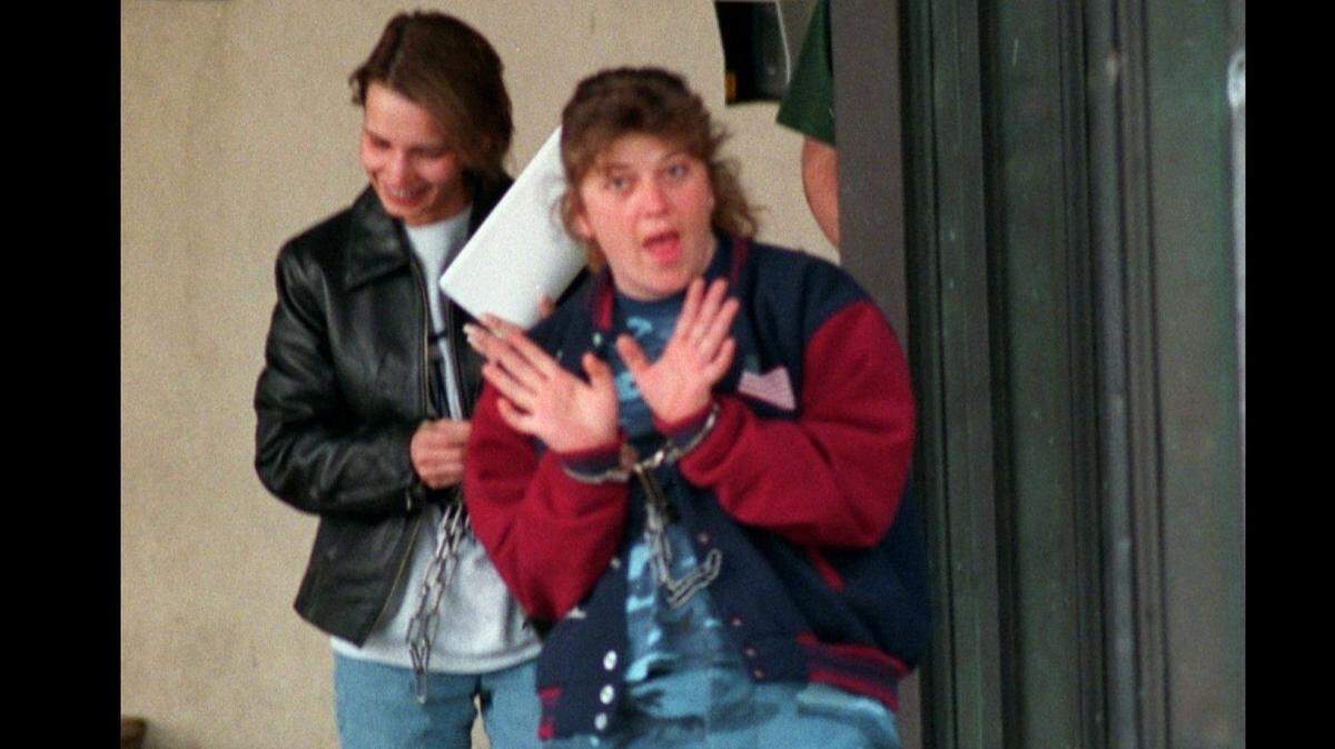 Michelle Chambers (left) and Kelly Campbell leave the federal courthouse in Charlotte on Nov. 3, 1998. Both women have paid just thousands of dollars to the U.S. government, well short of the millions they were ordered to pay in restitution for the 1997 Loomis Fargo heist.